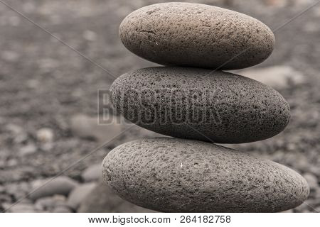 Three Round Rocks Piled Up. Taken In Djupalonssandur, Iceland.