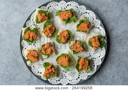 Canape With Muhammara, Adjika, Ajika Or Acuka On Small Square Breads With Round Plate.