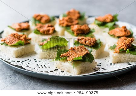 Canape With Muhammara, Adjika, Ajika Or Acuka On Small Square Breads With Round Plate.