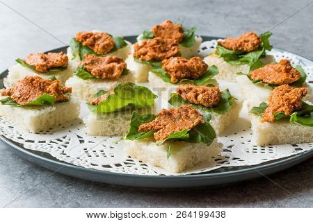 Canape With Muhammara, Adjika, Ajika Or Acuka On Small Square Breads With Round Plate.