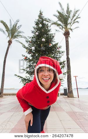 Christmas, Holidays And Humor Concept - Young Happy Woman Have Fun In Christmas Suit At Summer Near 