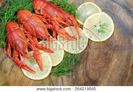 Crayfish And Lemons On A Wooden Table