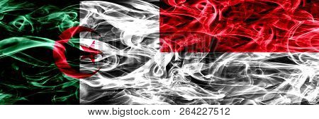 Algeria, Algerian Vs Monaco, Monacan Smoke Flags Placed Side By Side. Concept And Idea Flags Mix