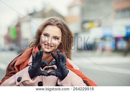 Love. Closeup Portrait Smiling Happy Young Woman Making Heart Sign, Symbol With Hands Isolated City 