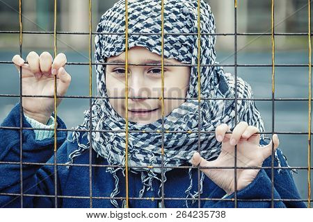 Crying Refugee Girl From The East In A Headscarf