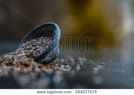 Close Up Of Ayurvedic Herb Alsi Or Adsi Or Flax Seed In A Black Colored Clay Bowl On Wooden Surface