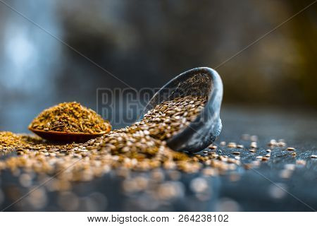 Close Up Of Ayurvedic Herb Alsi Or Adsi Or Flax Seed In A Black Colored Clay Bowl With Its Powder On