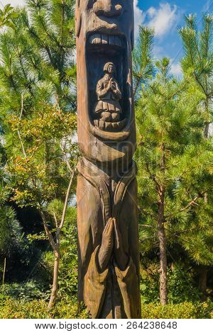 Samcheok, South Korea; September 25, 2018: Wooden Statue In Shape Of Human Penis With Young Woman In