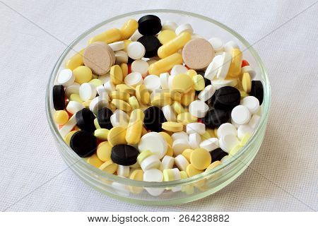 Life Without Drugs. Mixing Of Tablets In A Glass Petri Dish. White Fabric Background.