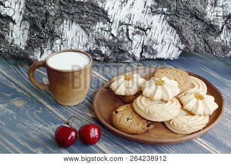 Dessert. Mug Of Milk And A Delicious Shortbread Cookie On A Clay Plate. Wooden Table Top And Birch B