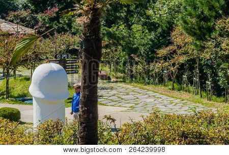 Samcheok, South Korea; September 25, 2018: Unidentified Man Wearing Glasses And Blue Jacket Next To 