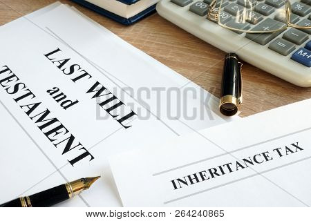 Inheritance Tax And Last Will And Testament On A Desk.