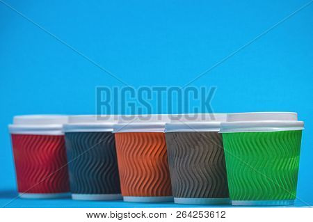 Colorful Cardboard Cups For Single Use On A Blue Background
