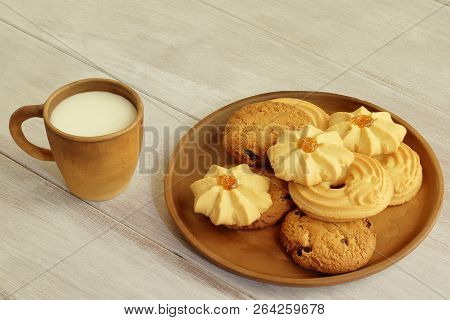 Tasty Breakfast. Hot Milk In Clay Cup And Fragrant Crumbly Cookies With Raisins Nuts And Jam On Cera