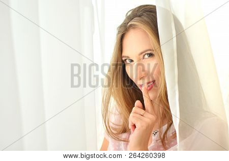 Shh! Secret And Quiet Gesture With A Copy Space. Woman Puts Finger On Lips. Intrigue Concept.