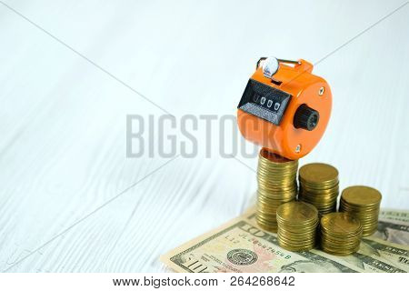 Tally Counter Or Counting Machine With 0000 Number, Coin And Banknote On White Wooden Table, Busines