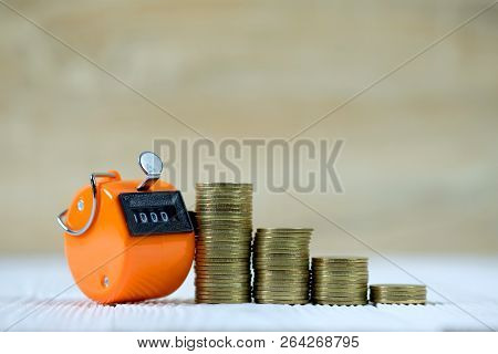 Tally Counter Or Counting Machine With 0000 Number, Step Of Coin Stack On White Wooden Table, Busine