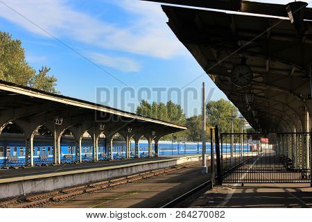 Rural Outdoor Platform Of Old City Train Station With No Passengers And No Trains. Empty Old Platfor