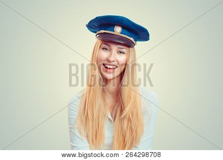 Charming Young Blond Woman In White Shirt And Blue Forage Cap Smiling At Camera