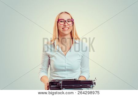 Happy Young Blond Woman In Glasses Sitting With Vintage Typewriter Smiling At Camera