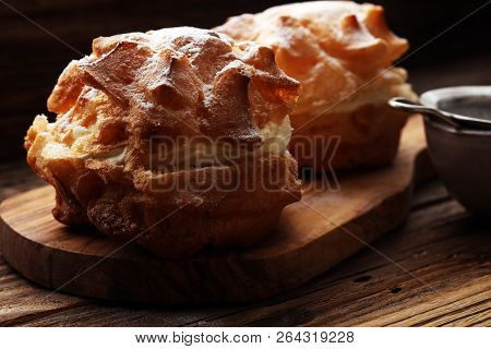 Cream Puffs. Homemade Pastry Cream Puff On Wooden Background