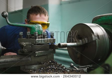 Turner Worker Is Working On A Lathe Machine In A Factory.