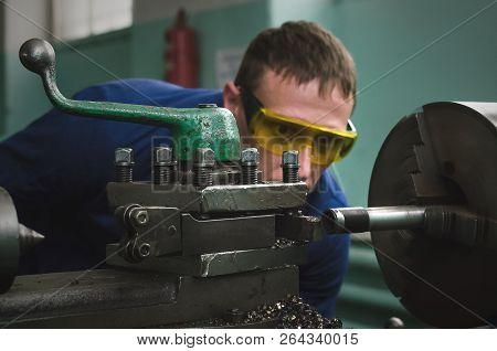 Turner Worker Is Working On A Lathe Machine In A Factory.