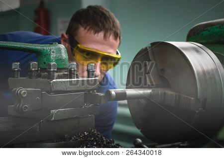 Turner Worker Is Working On A Lathe Machine In A Factory.