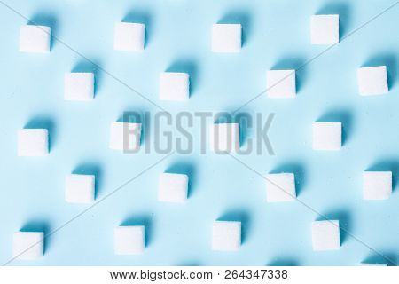 Sugar Cubes Regular Pattern On Blue Background, Flat Lay Top View Scene