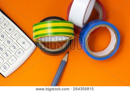 Calculator, Insulating Tape And Pencil On An Orange Background