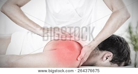 Highlighted pain against physiotherapist doing back massage 