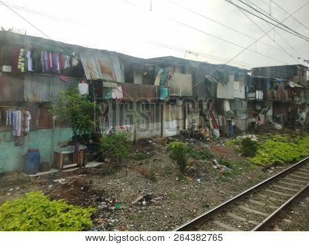 Jakarta, Indonesia - November 25, 2017: The Houses Of Squatters Along The Railroad Tracks In West Ja