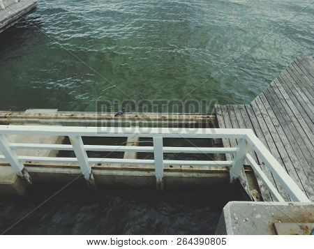 Broken Wooden Pier On Cloudy Day. Seaview