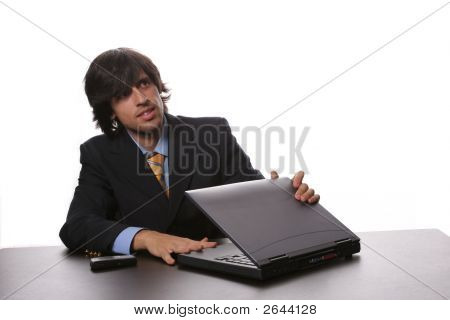 Young Bussiness Man Opening His Laptop At The Beggining Of The Day