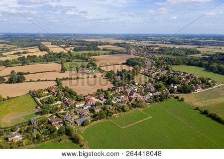 Aerial over village in countryside UK