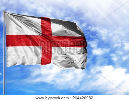 National Flag Of England On A Flagpole In Front Of Blue Sky