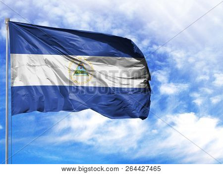 National Flag Of Nicaragua On A Flagpole In Front Of Blue Sky