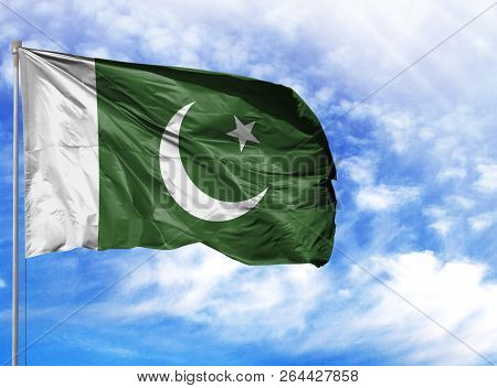 National Flag Of Pakistan On A Flagpole In Front Of Blue Sky