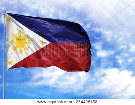 National Flag Of Philippines On A Flagpole In Front Of Blue Sky