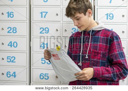 Happy Young Teenager Holding Recieved Mail Package With New Clothes Inside The Post Office