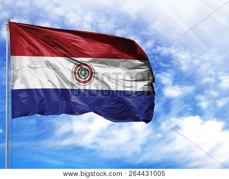 National Flag Of Paraguay On A Flagpole In Front Of Blue Sky