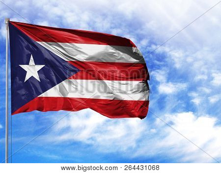 National Flag Of Puerto Rico On A Flagpole In Front Of Blue Sky