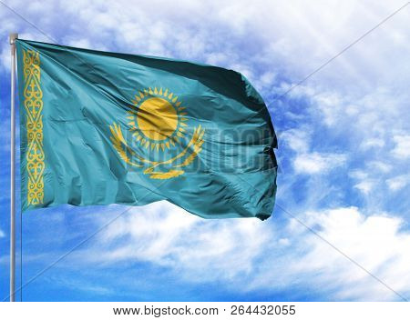 National Flag Of Kazakhstan On A Flagpole In Front Of Blue Sky