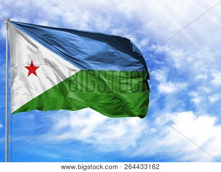 National Flag Of Djibouti On A Flagpole In Front Of Blue Sky