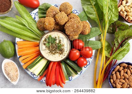 Colorful Vegetables, Lettuce, Falafels  And Humus On A Plate.