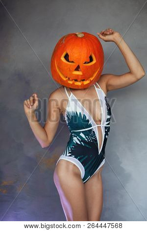 Sexy Woman With Carved Pumpkin On Her Head For Halloween