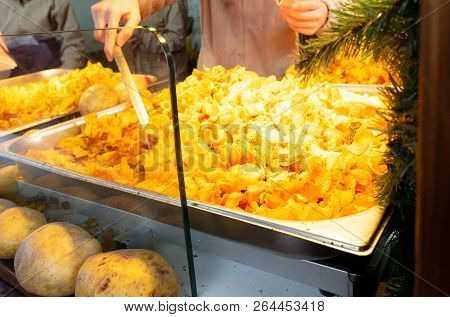 Tradiotional German Fried Potto At Christmas Market Kiosk