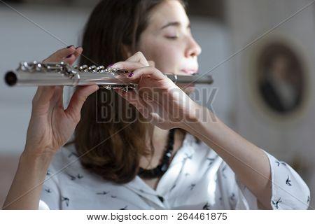 Girl Plays On Flute. Flute In Hands Of Girl During The Concert. Professional Musician Playing On Flu