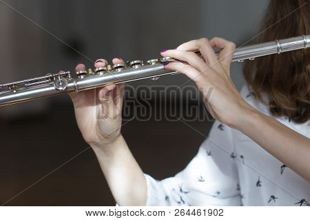 Girl Plays On Flute. Flute In Hands Of Girl During The Concert. Professional Musician Playing On Flu