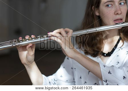 Girl Plays On Flute. Flute In Hands Of Girl During The Concert. Professional Musician Playing On Flu